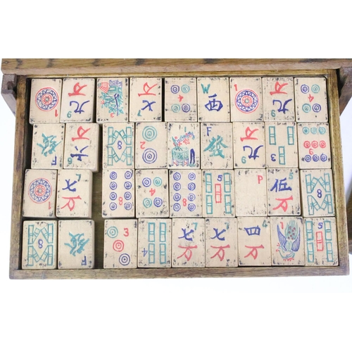178 - Chinese mahjong set with wooden tiles and metal playing pieces, housed within trays in a wooden case... 