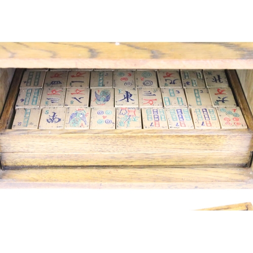 178 - Chinese mahjong set with wooden tiles and metal playing pieces, housed within trays in a wooden case... 