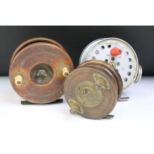 179 - A collection of three vintage fly fishing reels to include two wooden examples with brass fittings.