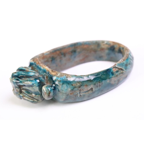 182 - An Egyptian faience bangle with green glaze and Ankh / key of life decoration to sides.