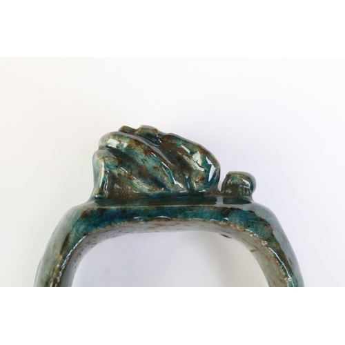 182 - An Egyptian faience bangle with green glaze and Ankh / key of life decoration to sides.