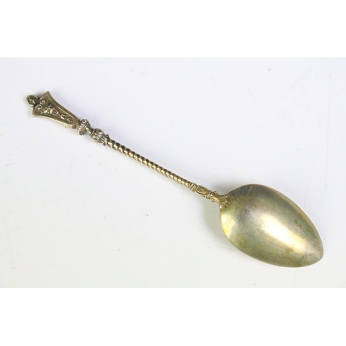 185 - A cased set of eighteen teaspoons, lions head to finials, gilt white metal stamped .830.