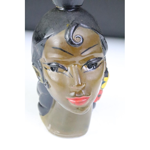 192 - An mid 20th century bottle in the form of a female head complete with contents.