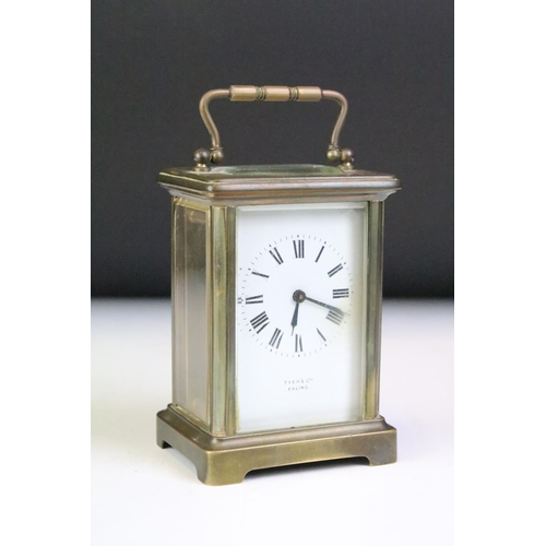 194 - A brass cased carriage clock with beveled glass panels, white enamel dial marked Tyer' Ltd, Ealing, ... 