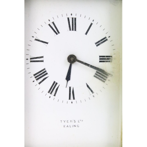 194 - A brass cased carriage clock with beveled glass panels, white enamel dial marked Tyer' Ltd, Ealing, ... 