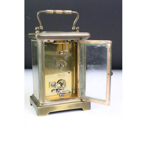 194 - A brass cased carriage clock with beveled glass panels, white enamel dial marked Tyer' Ltd, Ealing, ... 