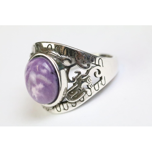 212 - A 925 sterling silver ladies ring with purple cabochon central stone with decorative shoulder work, ... 