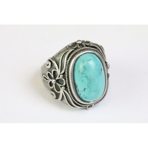 217 - A 925 Sterling silver with turquoise cabochon to centre ladies ring with decorative floral shoulders... 