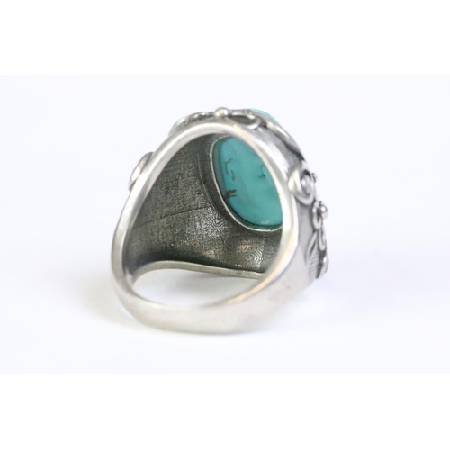 217 - A 925 Sterling silver with turquoise cabochon to centre ladies ring with decorative floral shoulders... 