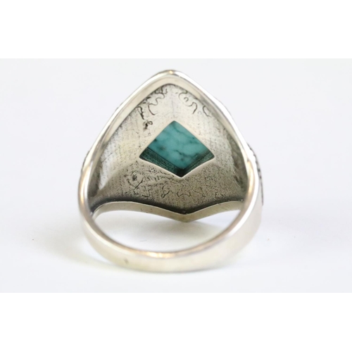 226 - A 925 sterling silver and turquoise ladies ring, decorative scroll pattern surrounding central turqu... 