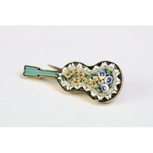 227 - A collection of four micro mosaic brooches to include two in the form of musical instruments