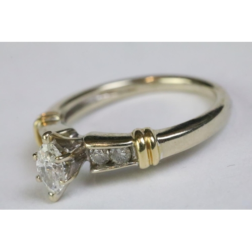 238 - 14ct yellow gold ring with central marquoise and brilliant cut diamond shoulders