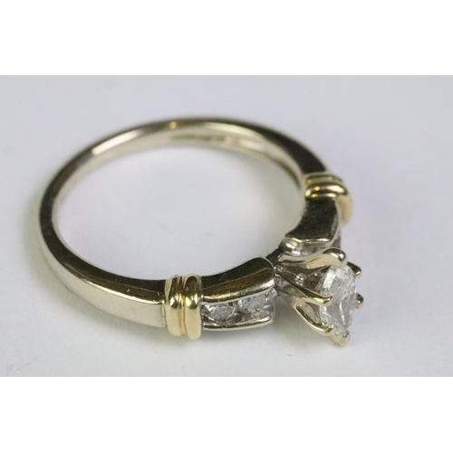 238 - 14ct yellow gold ring with central marquoise and brilliant cut diamond shoulders