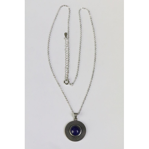 239 - A 925 sterling silver pendant set with central lapis lazuli cabochon, marked 925 to the verso and mo... 