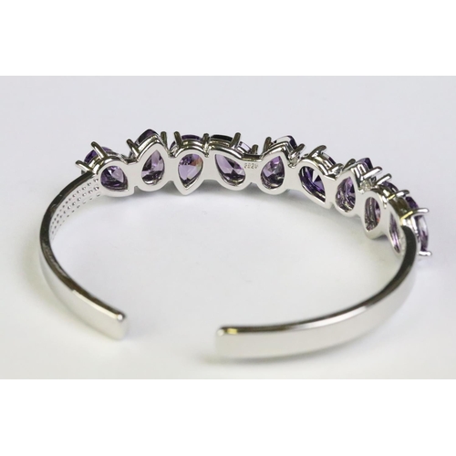 240 - A 925 sterling silver and amethyst open bangle bracelet, set with nine teardrop amethyst, marked 925... 