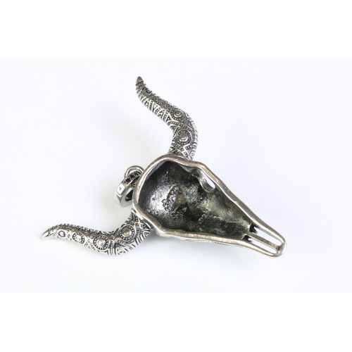 243 - A large 925 sterling silver pendant in the form of a steer / bulls head skull, set with five turquoi... 