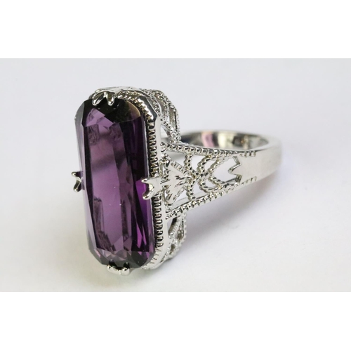 249 - A 925 sterling silver and amethyst ladies traditional dress ring, set with large central amethyst, p... 