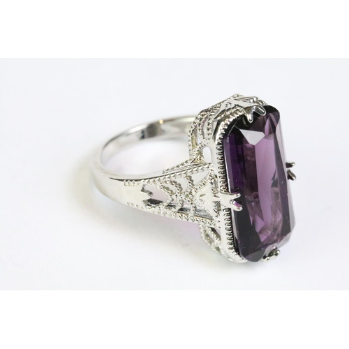 249 - A 925 sterling silver and amethyst ladies traditional dress ring, set with large central amethyst, p... 