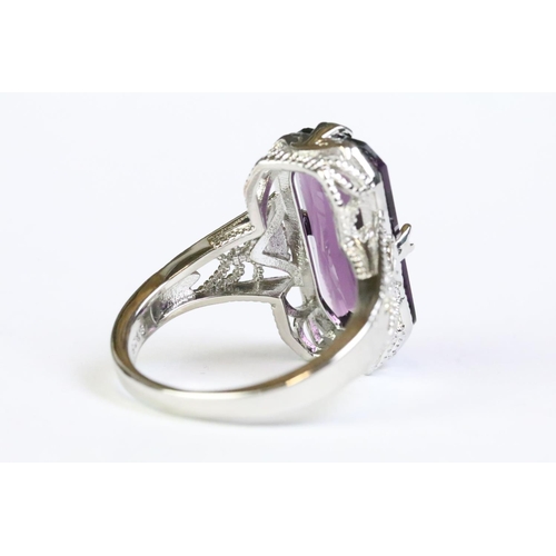 249 - A 925 sterling silver and amethyst ladies traditional dress ring, set with large central amethyst, p... 