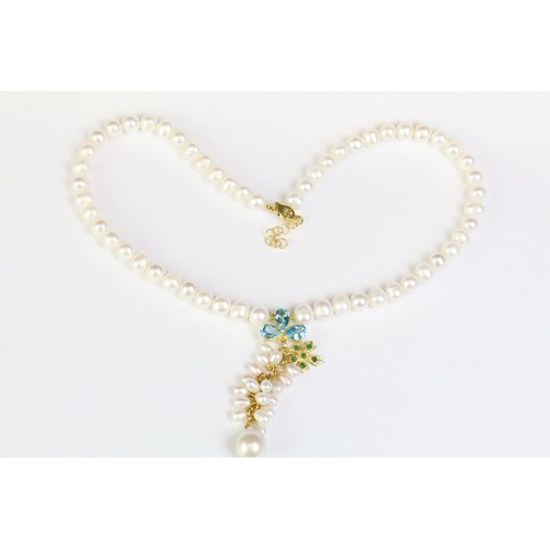 252 - Freshwater pearl necklace with a blue topaz and emerald clasp