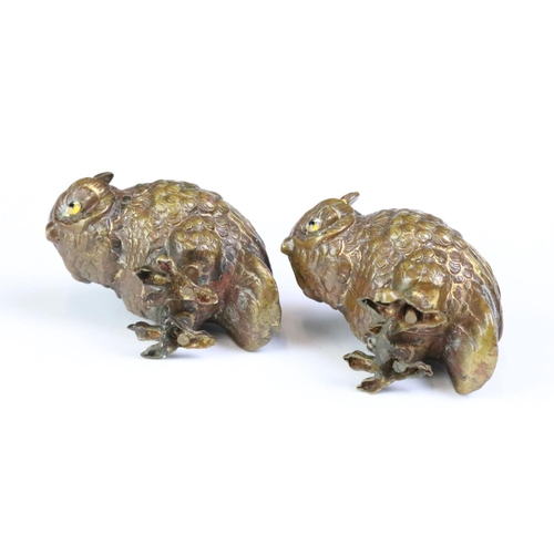 261 - A set of four bronze owl figures set with coloured glass backs.