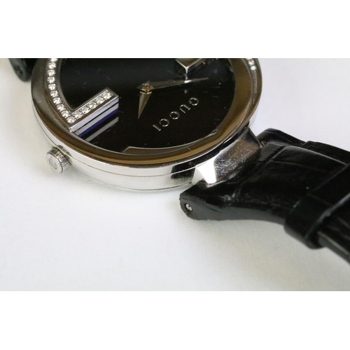 271 - Ladies Gucci diamond bezel wristwatch on black leather strap, complete with display box.