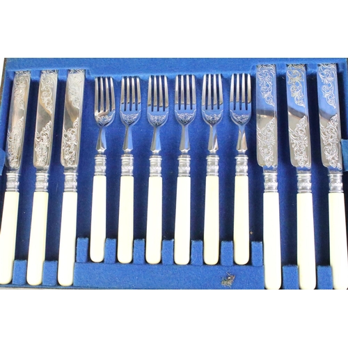 275 - A canteen of silver plated cutlery on faux ivory handles, complete with key.