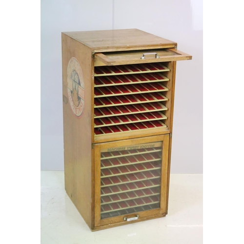 542 - Early 20th century Dewhurst's Sylko two door oak haberdashery / thread storage cabinet, marked in gi... 