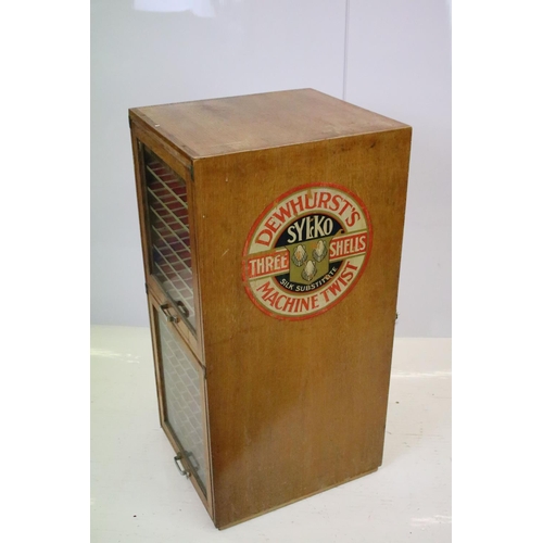 542 - Early 20th century Dewhurst's Sylko two door oak haberdashery / thread storage cabinet, marked in gi... 