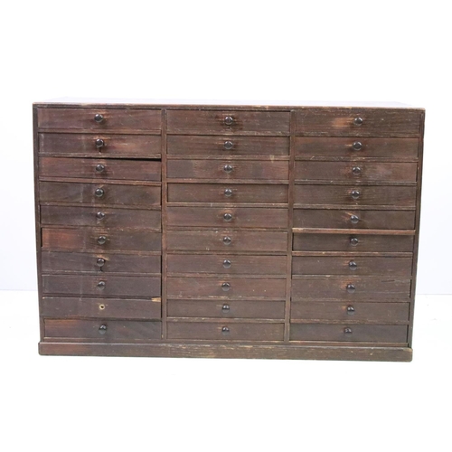 557 - Collectors cabinet, an arrangement of thirty drawers, 52cm high x 77cm wide x 32cm deep