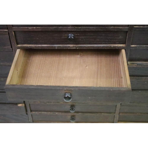 557 - Collectors cabinet, an arrangement of thirty drawers, 52cm high x 77cm wide x 32cm deep