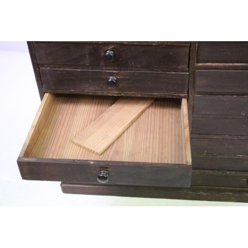 557 - Collectors cabinet, an arrangement of thirty drawers, 52cm high x 77cm wide x 32cm deep