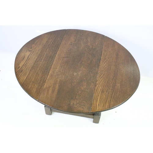 565 - 20th century oak drop leaf occasional coffee table on turned supports, 47cm high x 69cm wide x 57cm ... 