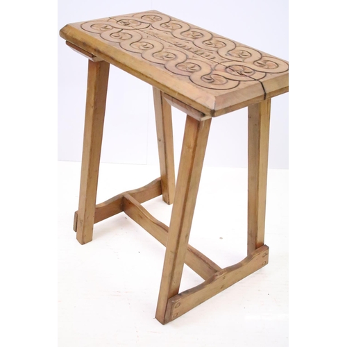 571 - Rustic pine stool, the top with geometric carved design, 56cm high x 48cm wide x  32.5cm deep