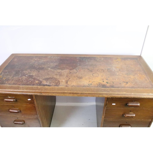 572 - Mid century mahogany twin pedestal desk with leather inset top, above an arrangement of eight drawer... 