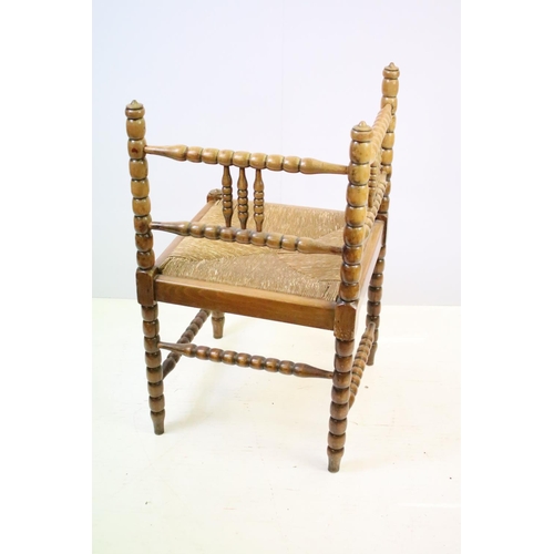 573 - Bobbin turned corner chair, with rush seat, 73.5cm high x 42cm wide x 42cm deep