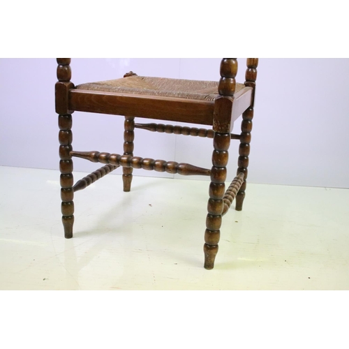 573 - Bobbin turned corner chair, with rush seat, 73.5cm high x 42cm wide x 42cm deep