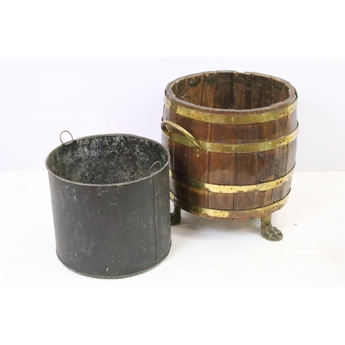 584A - Coopered barrel log basket / coal bucket with brass banding and twin brass handles on brass lion paw... 