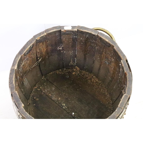 584A - Coopered barrel log basket / coal bucket with brass banding and twin brass handles on brass lion paw... 