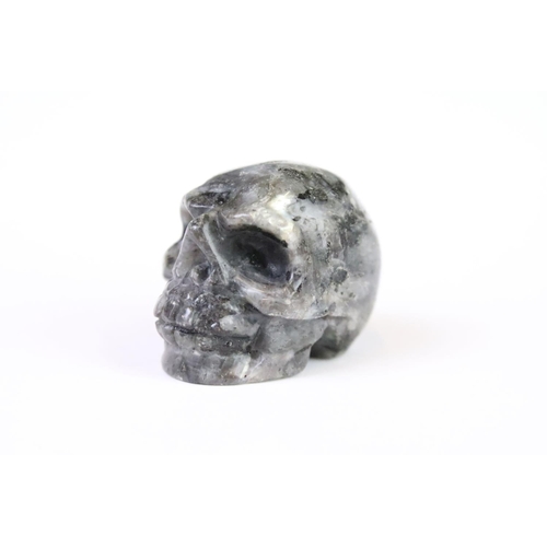 200A - A collection of three carved and polished semi precious stones in the form of human skulls.