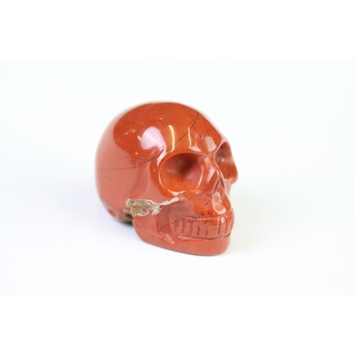 200A - A collection of three carved and polished semi precious stones in the form of human skulls.