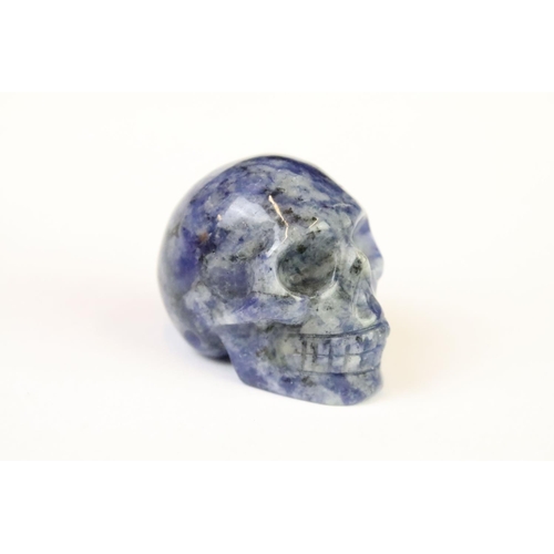 200A - A collection of three carved and polished semi precious stones in the form of human skulls.