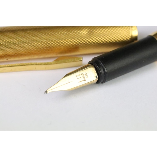 202A - A vintage Dunhill gold plated fountain pen with 14ct gold nib, Alfred Dunhill logo stamped to pin li... 