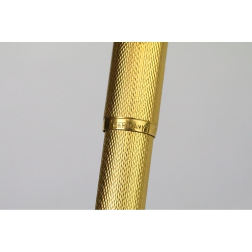 202A - A vintage Dunhill gold plated fountain pen with 14ct gold nib, Alfred Dunhill logo stamped to pin li... 