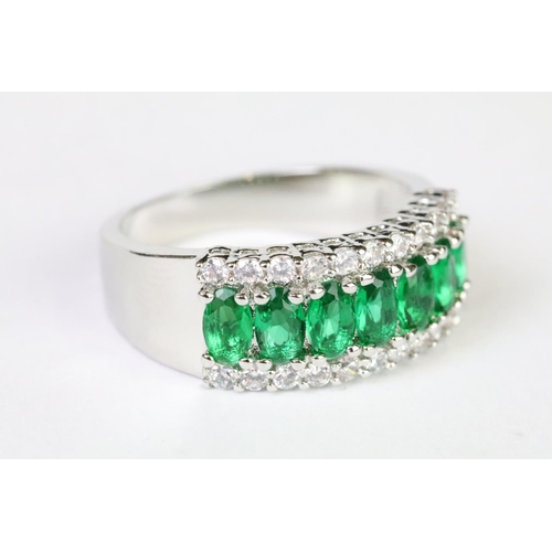 211A - A 925 sterling silver ladies dress ring in the Art Deco style set with green and clear stones, marke... 