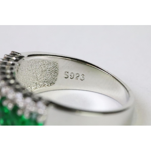 211A - A 925 sterling silver ladies dress ring in the Art Deco style set with green and clear stones, marke... 