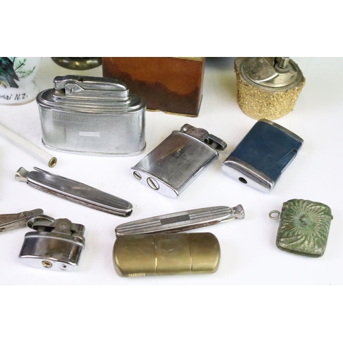 283 - A collection of smoking related collectables to include table lights, pocket lighters, vesta case...... 