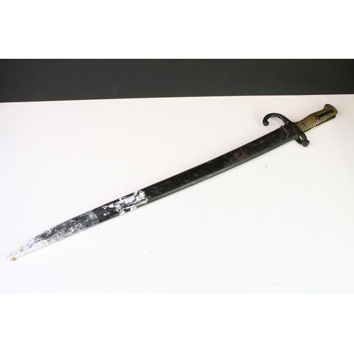 295 - A French World War One sword bayonet complete with scabbard.