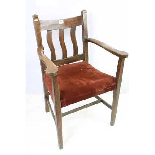 559A - Pair of oak elbow chairs, one with rush seat and another with a corduroy seat, 96cm high x 60cm wide... 