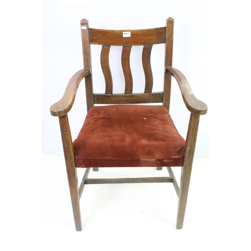 559A - Pair of oak elbow chairs, one with rush seat and another with a corduroy seat, 96cm high x 60cm wide... 